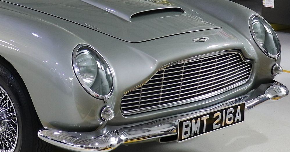 Close-up of the Aston Martin DB5’s chrome grille, bumper and round headlamp