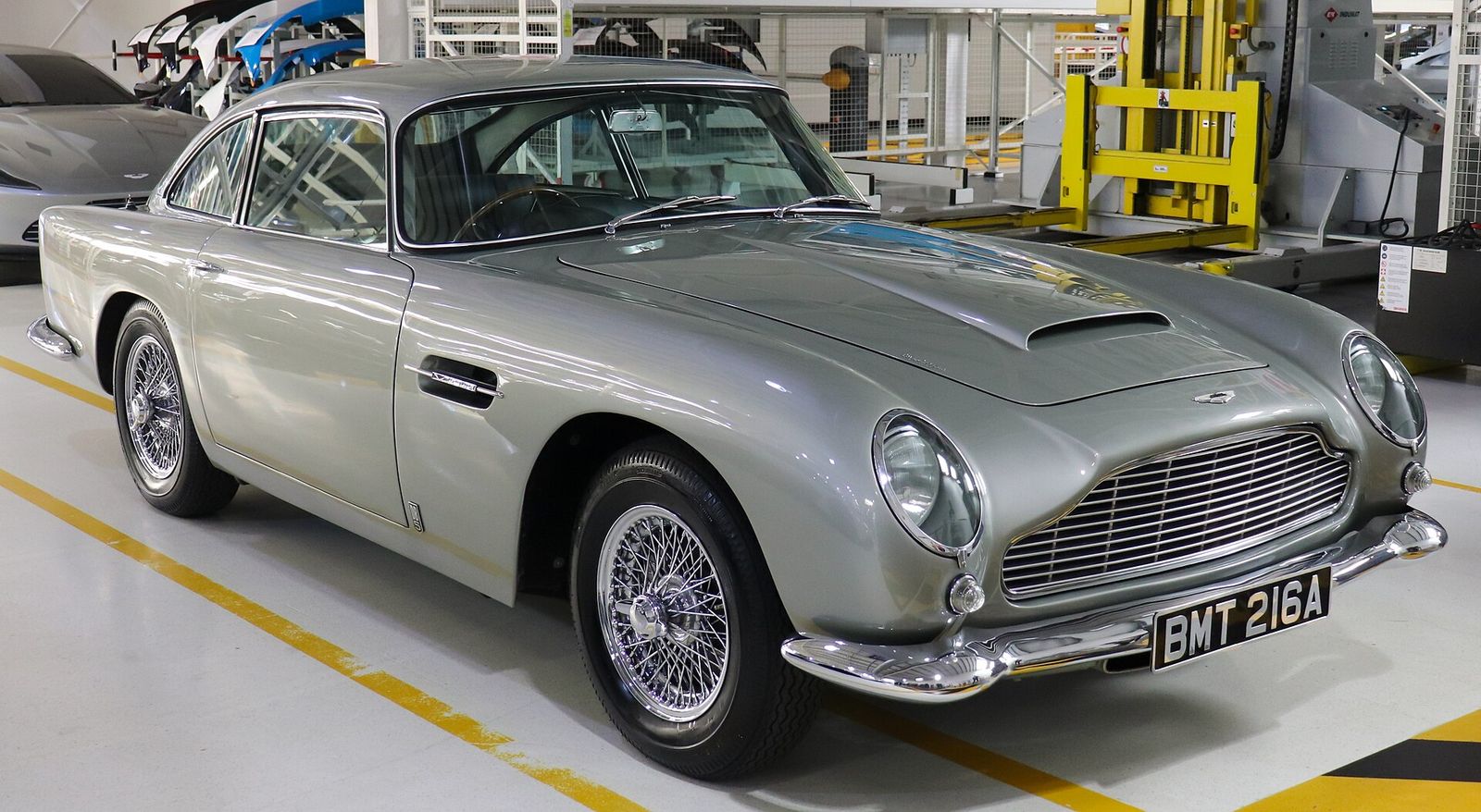 Silver 1964 Aston Martin DB5 seen from the front, parked inside the Aston Martin factory at Gaydon