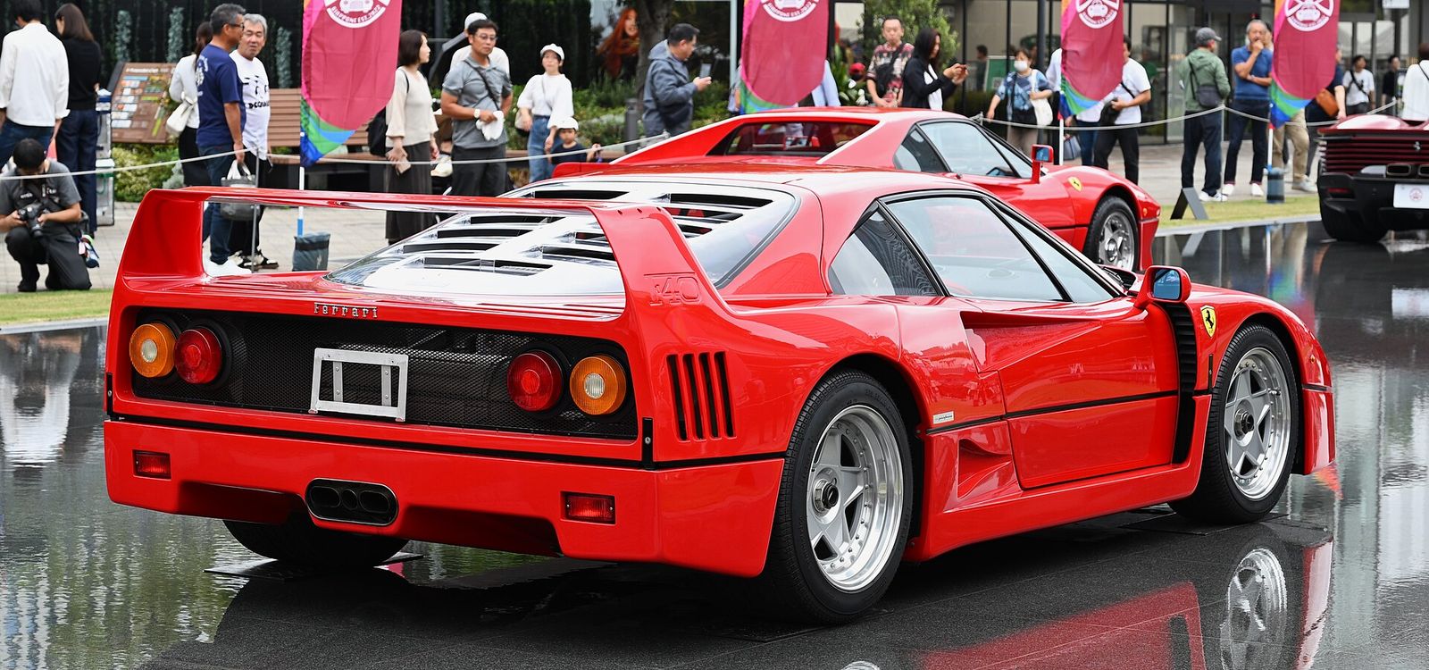Rear view of a red 1990 Ferrari F40 showing its full-width wing and slatted engine cover